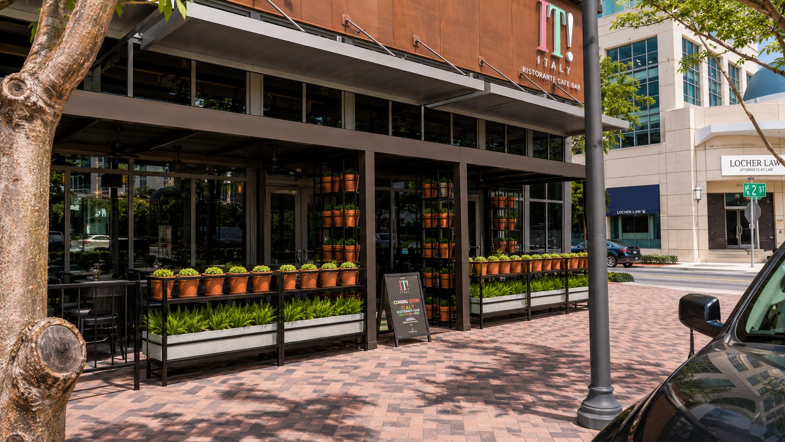 Aluminum canopy running the length of a restaurant's sidewalk dining terrace